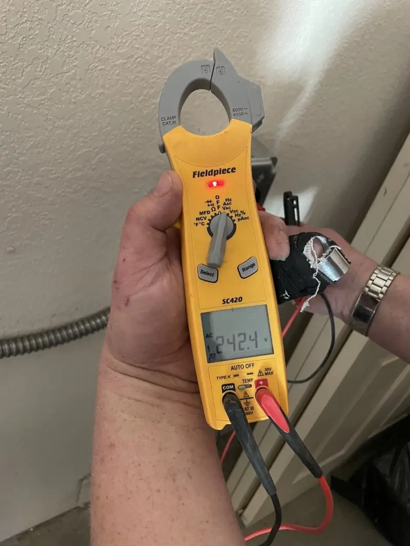 Voltage testing with clamp meter during Recessed Lighting Installation in Kingston